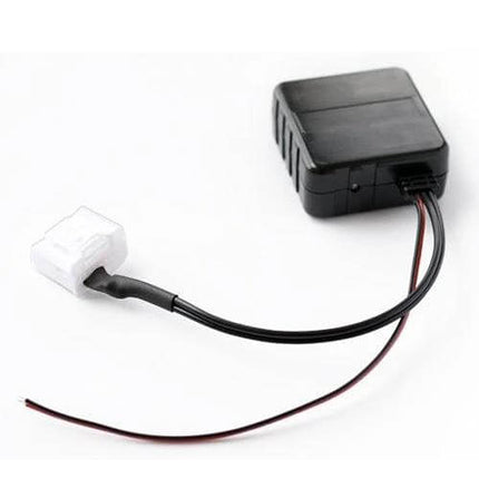 Car Wireless Bluetooth Module Aux Adapter Cable For Toyota plugged into CD changer port, compact black module with white connector and wiring