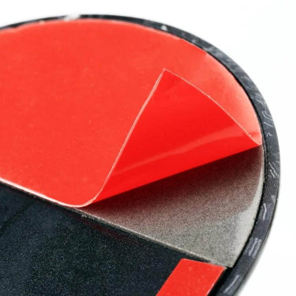 Car Imitation Engine Lock Body Decorative Stickers, 2-Pack adhesive backing close-up showing red peel-away film on plastic sticker