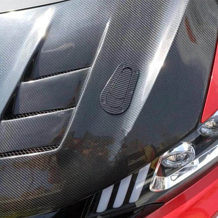 Car Imitation Engine Lock Body Decorative Stickers, 2-Pack applied on carbon-fiber style car hood near headlight for interior/exterior accent