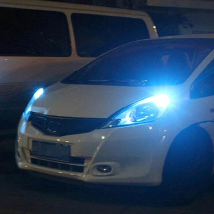 2 Pack T10 5W SMD 2835 9LED Car Clearance Lights, DC 12V shown installed on a white car at night, bright blue-white illumination