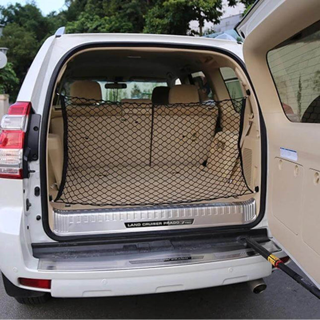 Universal Fit Mesh Cargo Storage Organizer for Vehicle Trunks installed in SUV trunk securing luggage and groceries during travel
