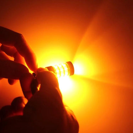 Dual Color LED Car Brake and Turn Signal Light For 12V shown glowing amber in hand to demonstrate turn-signal mode