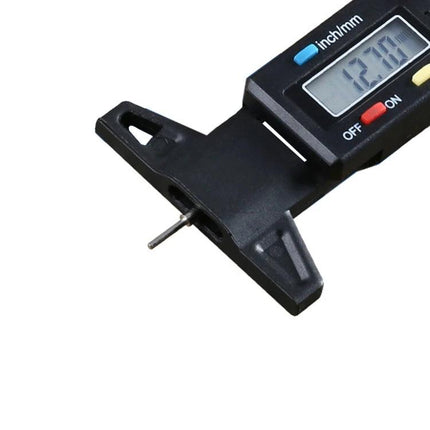 Handy Gauge for Checking Tire Tread During Vehicle Maintenance - digital tread depth gauge showing 12.10mm measurement