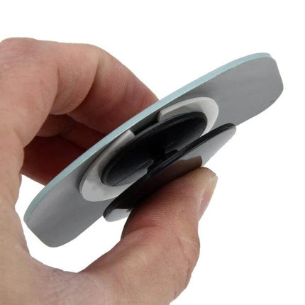 Wide Angle Adjustable Oval Blind Spot Mirror for Vehicles held between fingers showing adhesive back and swivel mount