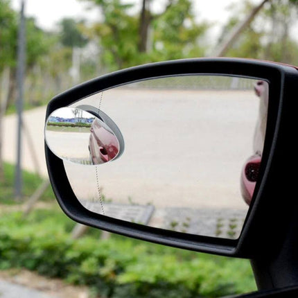 Wide Angle Adjustable Oval Blind Spot Mirror for Vehicles attached to car side mirror showing expanded view of blind spot