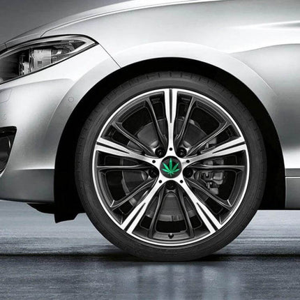 Green Leaves Pattern Metal Stickers for Car Wheel Hubs, 4 Pack applied to silver car rim center showing green leaf design for wheel hub customization