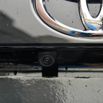 Waterproof Universal Car Rear View Backup Camera for Reversing mounted under car emblem showing waterproof camera lens