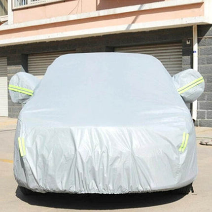 XL Sunproof Car Cover for Sedans with Warning Strips protecting a silver sedan outdoors from sun, UV rays and dust with reflective warning strips visible