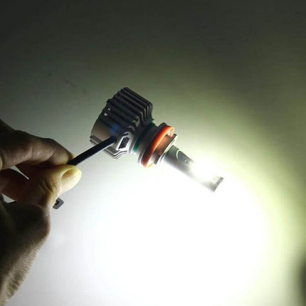 Two Pack Car LED Headlight Bulbs For DRL And Night Driving - CANBUS-compatible COB LED bulb illuminated in hand, wide even beam for cars, trucks, SUVs
