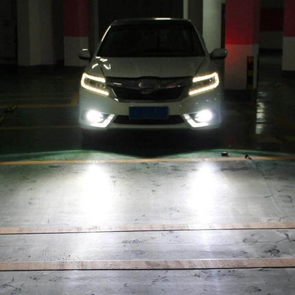PSX24W Car Fog Lights, 2 Pack, White And Yellow Light installed on a parked car illuminating road edges in foggy/low‑light conditions