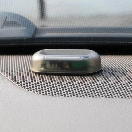 LQ-S10 Car Solar Dummy Alarm Light Blue Flashing Security Lamp mounted on car dashboard showing compact solar LED deterrent