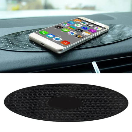 30x9.5cm Oval Rubber Anti-Slip Mat for Car Dashboard Devices holding a smartphone and sunglasses securely on a car dashboard, non-slip rubber oval mat