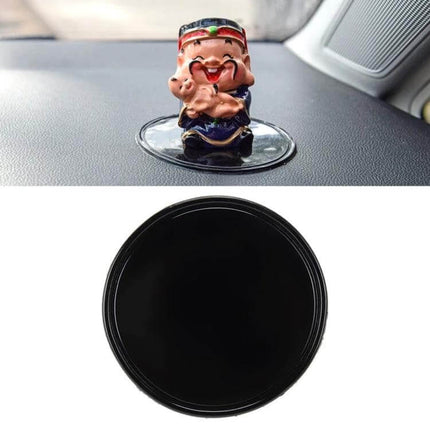 Round Soft Rubber Dashboard Anti-Slip Mat for Phones and GPS shown holding a small dashboard figurine on car dash