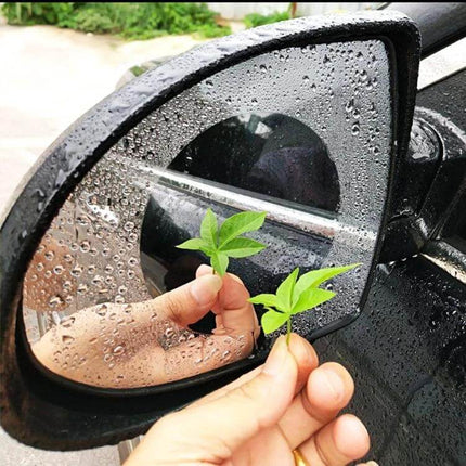 Clear Anti-Fog Protective Film for Car Rearview Mirrors, 8cm Diameter on wet side mirror showing clear circular patch and improved visibility