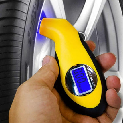 Cedar Digital Gauge for Checking Tire Pressure on Daily Drives handheld yellow gauge showing digital reading attached to car tire valve stem