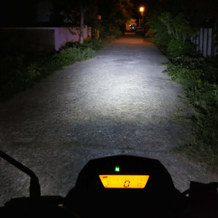Bright White Headlights for Motorcycle Night Use illuminating a dim road from rider perspective