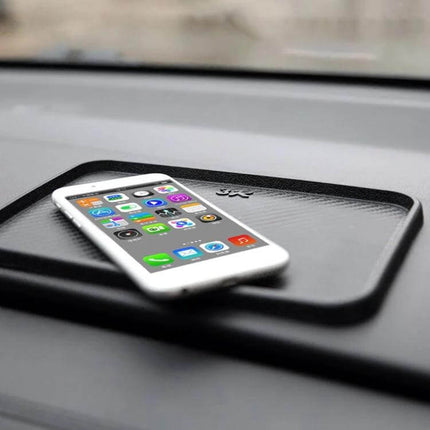 Multi-Purpose Car Dashboard Anti-Slip Mat for Securing Devices holding a smartphone and sunglasses on a car dashboard without residue