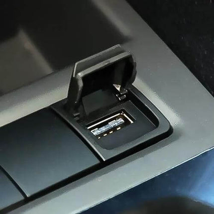 USB Adapter Switch Plug For VW Vehicles In Car Use - close-up of black USB port with protective flip cover for VW Golf/Sagitar/Scirocco/Magotan