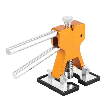 A Versatile Kit for Everyday Car Dent Repairs – orange hand-operated dent puller tool with adjustable arms and base for driveway car dent removal