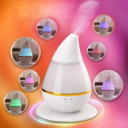 Ultrasonic USB Humidifier Purifier With Aroma Atomizer on desk emitting mist with color-changing night light