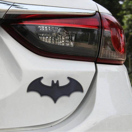 Bat-Shaped Shining Metal Decal for Everyday Car Styling on white car trunk near taillight, durable metal bat emblem for subtle exterior personalization