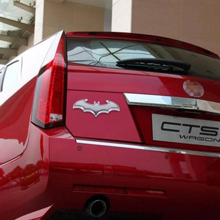 Bat-Shaped Shining Metal Decal for Everyday Car Styling on red hatchback trunk showing silver bat emblem