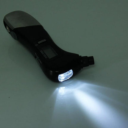 Essential Multi-Tool for Travel and Vehicle Safety digital tire gauge with LED light in use