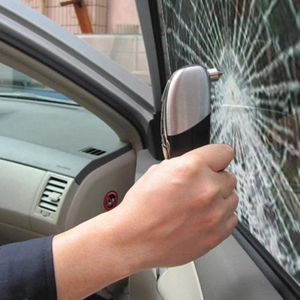 Essential Multi-Tool for Travel and Vehicle Safety - hand using glass-breaker tool to shatter car window for emergency access