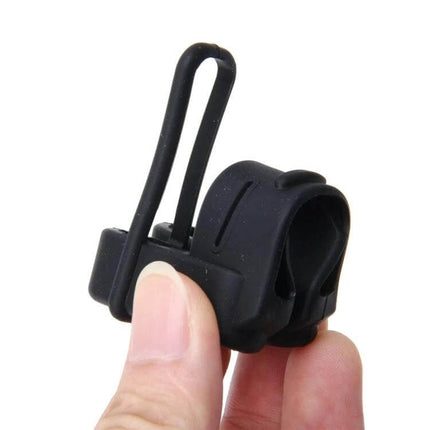 Universal Adjustable Protective Cover for Car Seat Belt Buckles in black silicone held between fingers to reduce buckle noise and protect metal parts