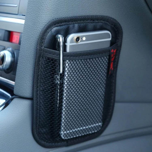 Car Seat Storage Bag for Organizing Essentials in Vehicles attached to seat holding phone and pen, keeping car interior tidy and items secure