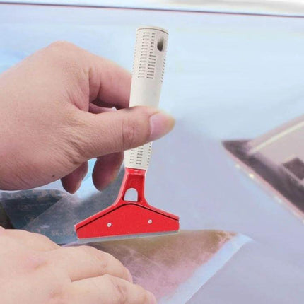 Metal Blade Tool for Car Window Film Installation and Scraping being used to smooth and scrape film on a car window