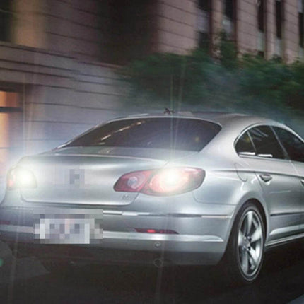 Rear view of sedan with illuminated Dual Color Car Brake Light Turn Signal Bulb Long Life showing bright brake and amber turn signals