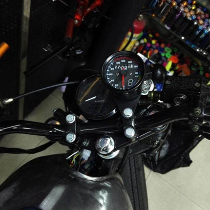 Universal Waterproof 3-in-1 Motorcycle Speedometer and Odometer mounted on motorcycle handlebars showing clear 0–160 km/h dial and LED backlight