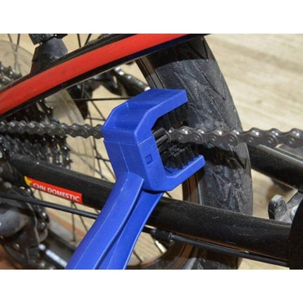 Blue Nylon Chain Cleaning Brush for Motorcycles and Bikes being used to scrub a bicycle chain and sprocket with durable nylon bristles