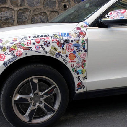 Universal Aluminium Wheel Disc Brake Cover Decorative on white car front wheel with sticker-covered fender, cross-drilled rotor look, corrosion-resistant aluminium