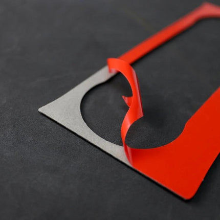Carbon Fiber Decorative Sticker with German Flag for Mercedes C Class - close-up of red peelable backing on carbon-look decal showing adhesive edge