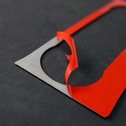 Carbon Fiber German Flag Decorative Sticker for Car Air Conditioning Knob shown peeled red adhesive on black background