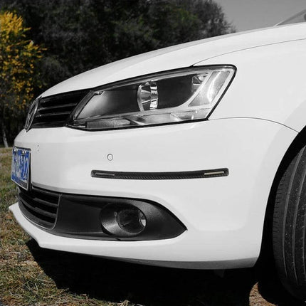 Universal Silicon Car Door Anti-Collision Strip, 4 Pieces installed on white car bumper to prevent dings and scratches