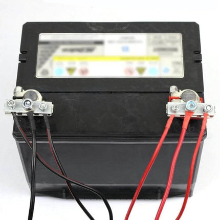 Foxsur Car Battery Terminal Clamp Kit For Wire Connectors attached to a car battery with red and black wiring for auxiliary power