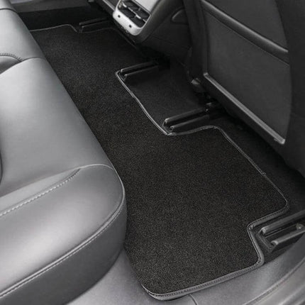 Velvet Foot Mat for Tesla Model 3 Vehicles Before 2021 installed in rear seating area, custom-fit black velvet surface protecting floor