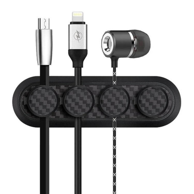 Carbon Fiber Magnetic Desk Cable Organizer for Storage with four magnetic buckles holding charging and audio cables on carbon fiber base