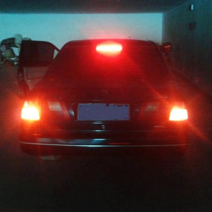 2-Pack LED Car Brake Lights For Everyday Driving Use glowing on rear of parked sedan showing bright center high-mounted stop lamp and brake lights