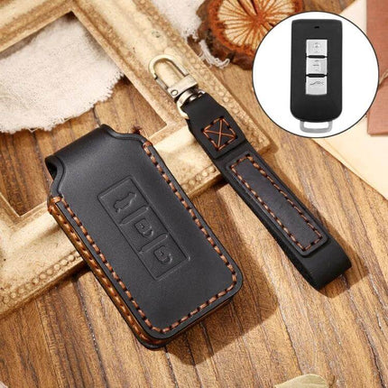 Hallmo Cowhide Leather Protective Key Case for Mitsubishi Outlander shown in black with stitched key fob cover and wrist strap
