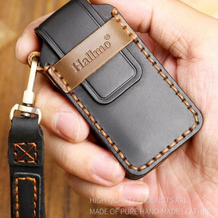 Hallmo Cowhide Leather Protective Key Case for Mitsubishi Outlander in brown black leather held in hand, stitched key fob cover with strap