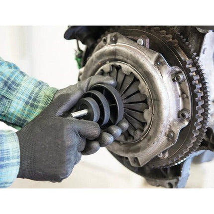 Essential Tool for Centering Parts in Vehicle Maintenance Tasks - technician aligning clutch disc with centering tool for single-handed installation