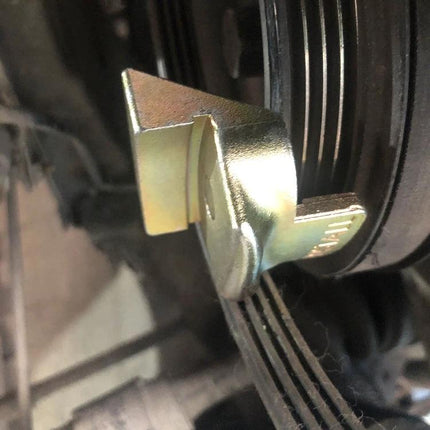 Essential Tool for Car Stretch Belt Maintenance at Home — close-up of metal belt holder securing pulley and multi-rib stretch belt for DIY removal and installation