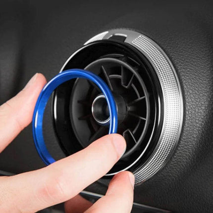 Metal Decorative Rings for Audi A1 Air Vent, 4-Piece Set - blue ring being fitted onto circular air vent for subtle interior upgrade