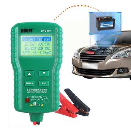 DUOYI Device for Routine Car Battery Checks in Daily Maintenance - handheld green DY219A tester showing results with clamps beside car