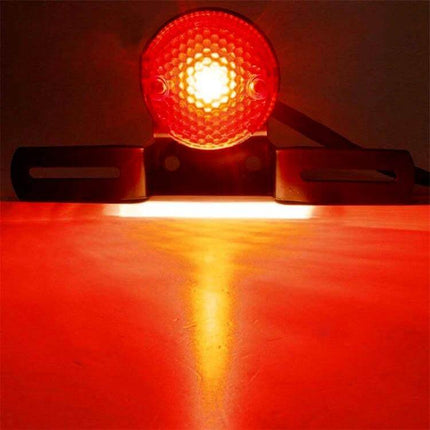 Retro Round Motorcycle Brake Light with License Plate Holder mounted and illuminated showing rear red LED brake light and license plate holder