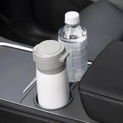 Shunwei Car Water Cup Holder for Tesla Model 3 and Y 2021-2022 shown holding water bottle and travel mug in center console